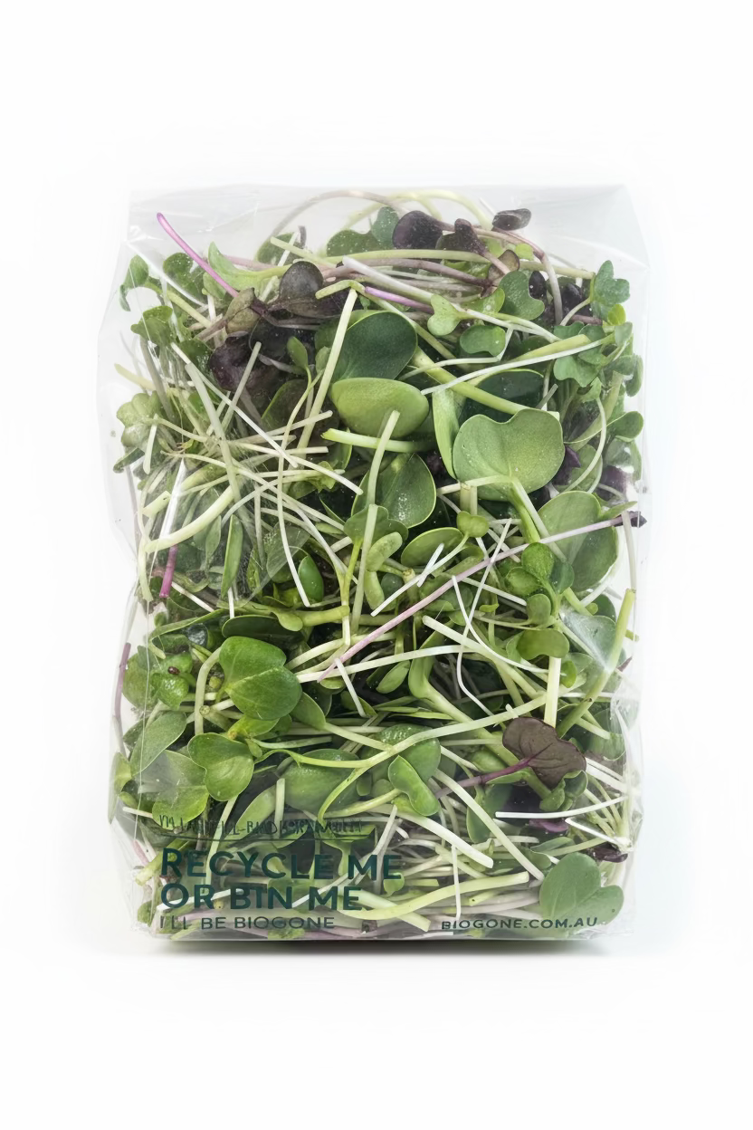 Packaged microgreens in a clear plastic bag on a wooden surface